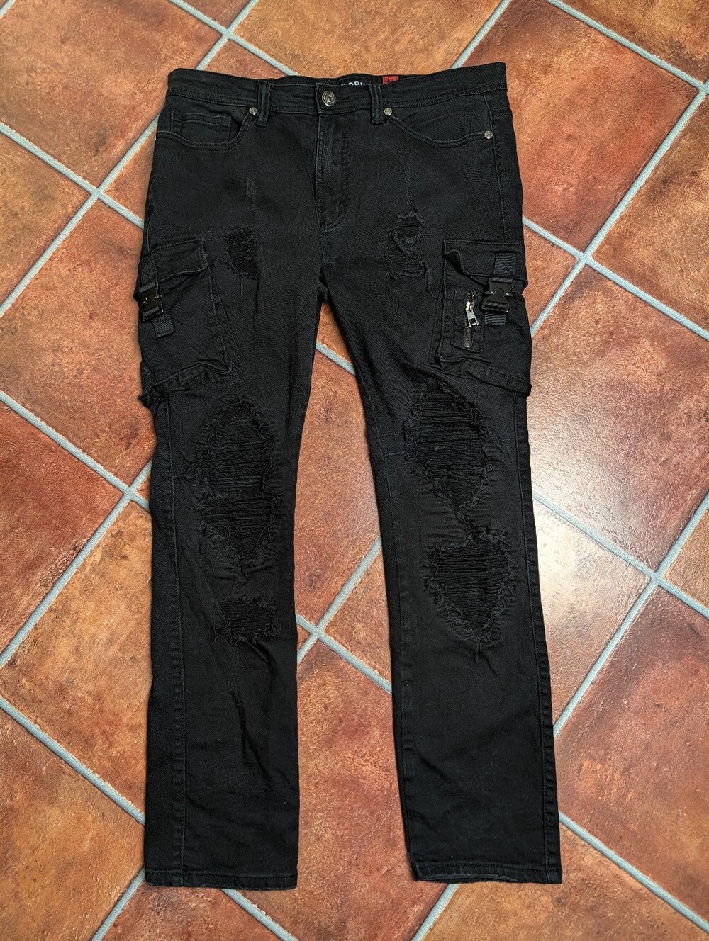 Makobi Seat Belt Buckle Distressed Cargo Jeans in Black